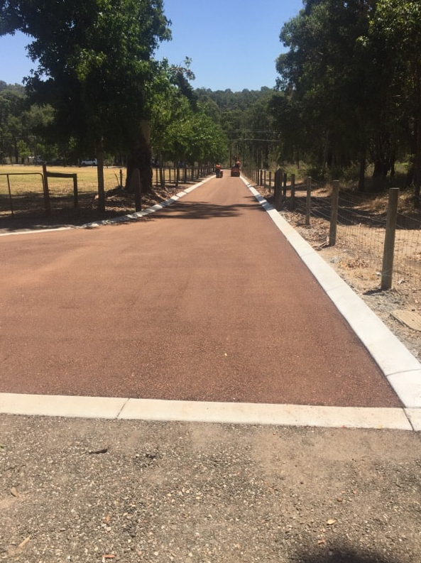 This is a photo of a hot spray & seal bitumen roadway which is in the process of being installed by Richmond Surfacing Solutions